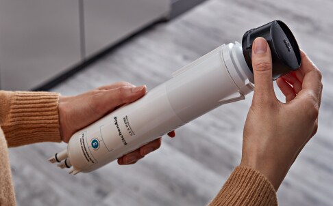 Removing cap from water filter